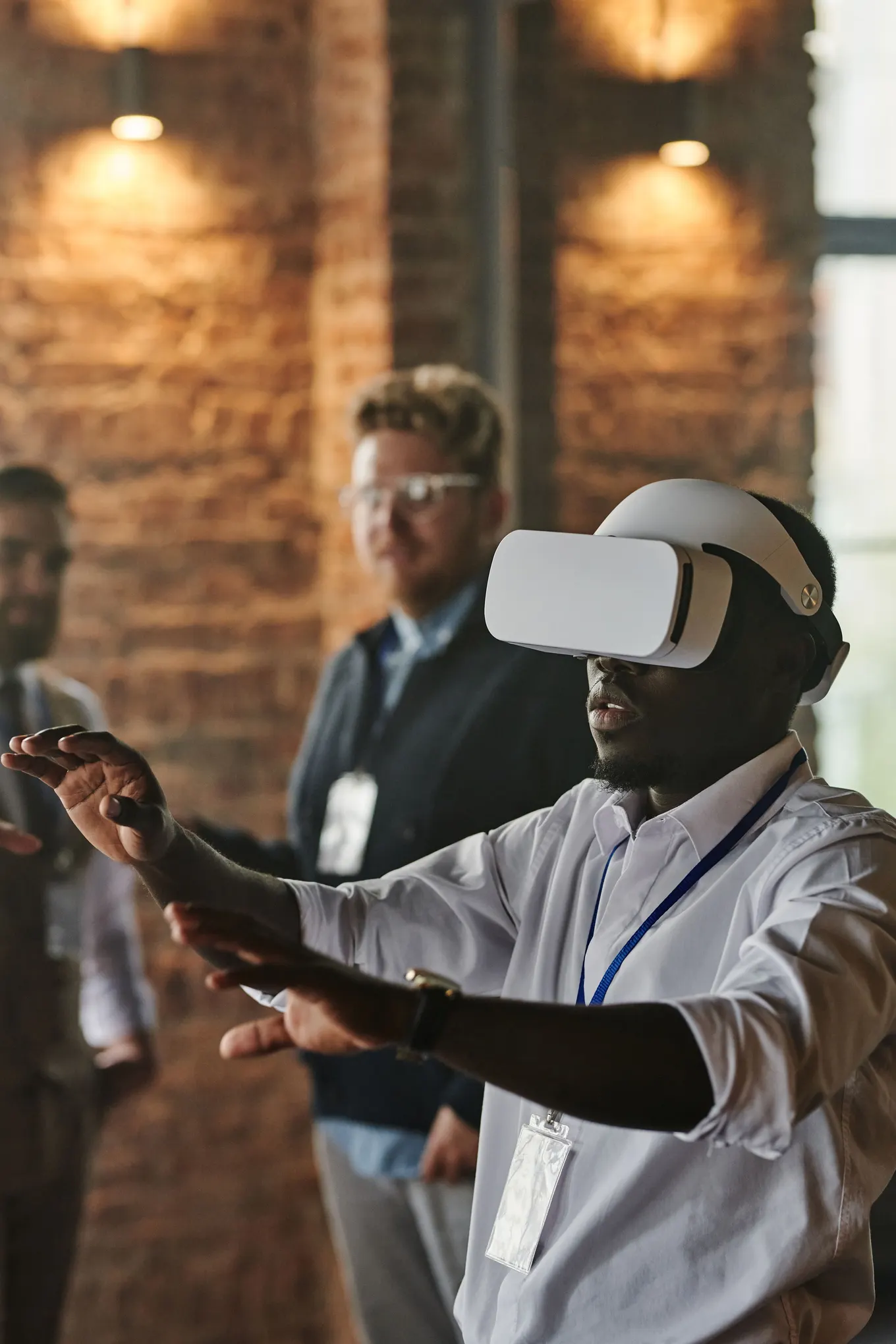Professional demonstrating a virtual reality headset to colleagues in an office